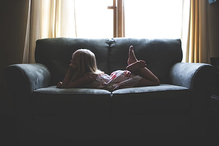 girl lying on gray sofa thumbnail