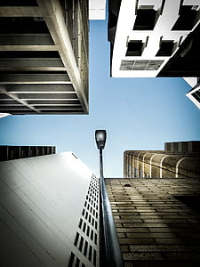 low-angle photography of black street light on high-rise building thumbnail