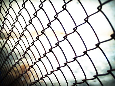 bokeh photography of black cyclone fence thumbnail