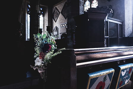 brown wooden pew with flower accent near cabinet thumbnail