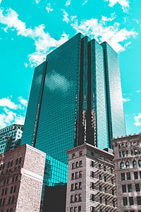 low-angle photography of high-rise building under clear blue sky during daytime thumbnail