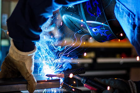 steel-wool photography of man welding gray metal part thumbnail