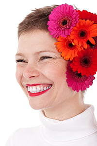 smiling woman with pink and red flowers on her ear thumbnail