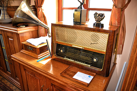 vintage brown AM/FM radio on cabinet thumbnail