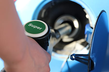 person filling gas in blue vehicle thumbnail