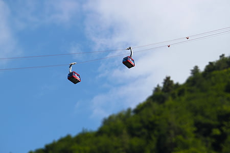 selective focus photograph of two red cable cars thumbnail
