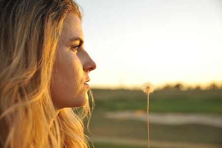 shallow focus photo of woman with white dandelion thumbnail