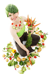 woman in green bondeau and black pants while holding bunch of carrots thumbnail