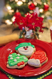 three christmas cookies on round red ceramic plate thumbnail