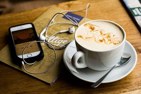 espresso in ceramic cup on saucer near on iPhone 5s thumbnail