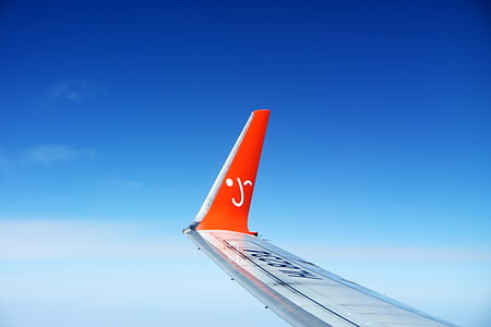 red and white airplane wing during daytime thumbnail