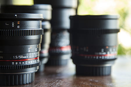 several assorted camera lens on brown table thumbnail