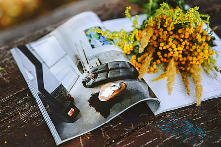 Yellow flowers with miscellaneous items on wooden floor thumbnail