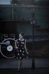 woman wearing black and white floral dress near post thumbnail