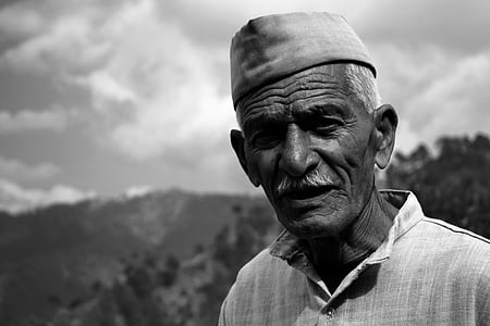 grayscale photography of man wearing hat and collared button-up shirt thumbnail