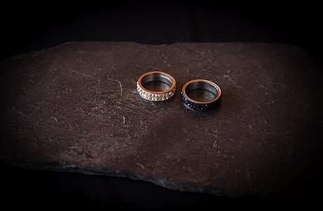 two silver-colored rings on gray slab thumbnail
