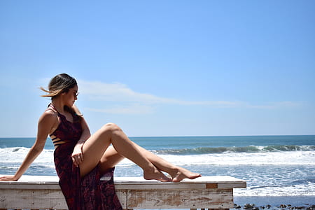 woman sitting on wooden bench thumbnail