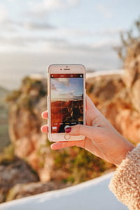 person taking photo of mountain thumbnail