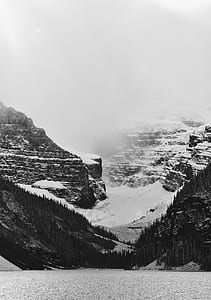 gray scale photo of mountain range covered with snow thumbnail