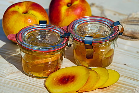 sliced peach fruit beside clear glass jars thumbnail