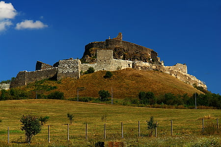 castle on mountain under blue sky thumbnail