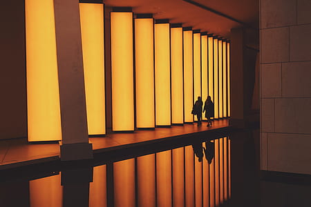 two person walking on hallway with orange lights thumbnail