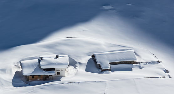 snow coated houses on field during daytime thumbnail