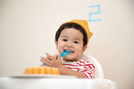 toddler sits next to cake thumbnail