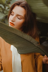 woman holding plants during daytime thumbnail