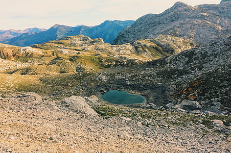 rocky mountain under white cloudy sky thumbnail