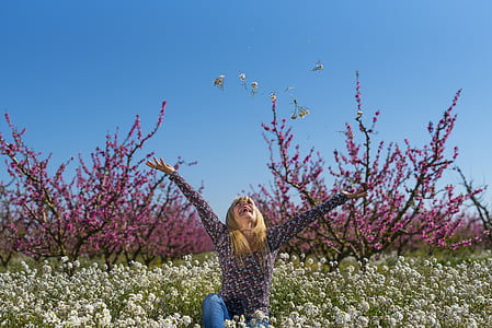 selective focus photography of woman in the middle of white flower field thumbnail
