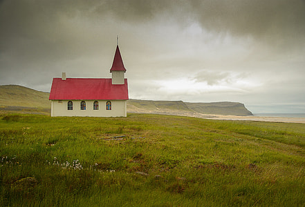 chapel in the middle of grass field under nimbus clouds thumbnail