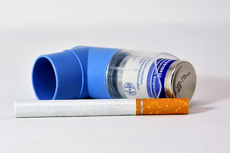 white cigarette stick beside blue inhaler thumbnail