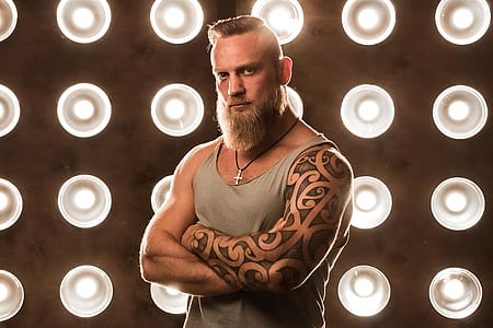 man wearing gray tank top beside lighted walls thumbnail