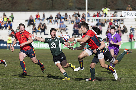 group of men playing rugby sport on field thumbnail