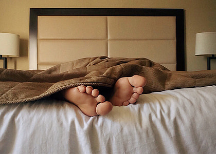 person's foot in brown comforoter thumbnail