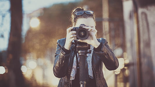 woman holding camera taking picture thumbnail