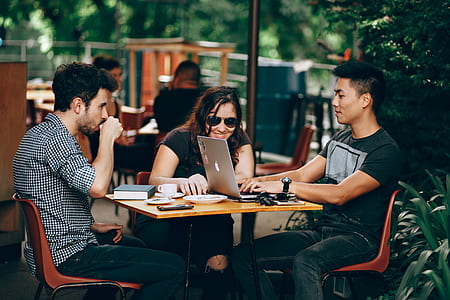 three people sits and talks to each other outdoors thumbnail