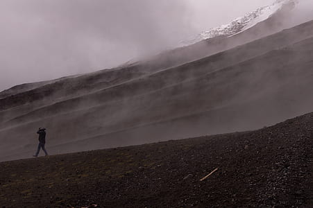 man standing on hill during daytime thumbnail