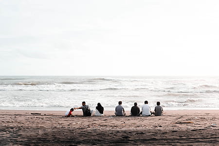 Group of People Sitting on Seashore thumbnail