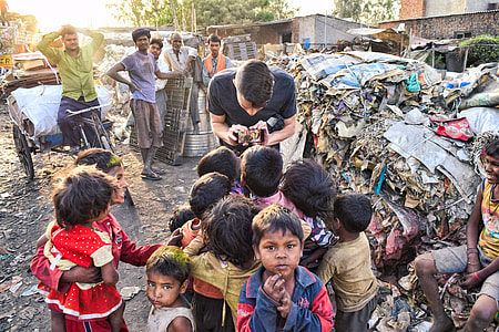 man showing his phone to group of children thumbnail