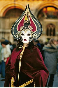 woman weawring red, white, and gray masquerade mask and red robe thumbnail