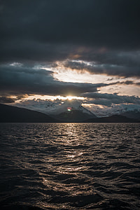 body of water and cloudy sky during daytime thumbnail