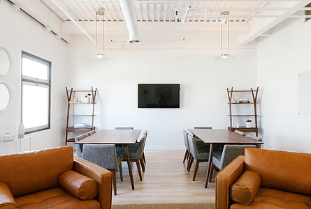 two rectangular brown wooden dining tables in front of black flat screen TV thumbnail