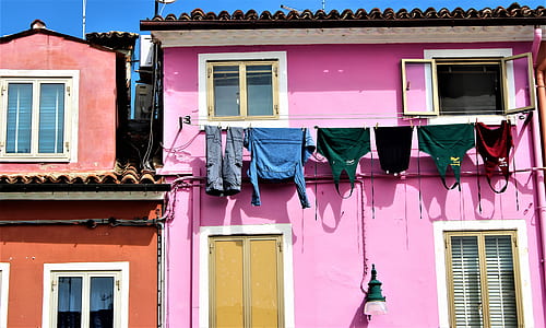 pink painted house with clothes hanging on cable thumbnail