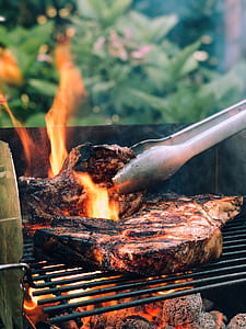 gray tong clipped steak photo thumbnail