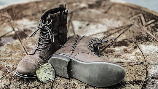 shallow focus photography of brown leather work boots thumbnail