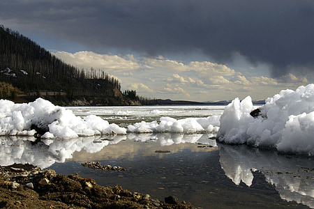 iceberg under blue and white cloudy skies at daytime thumbnail