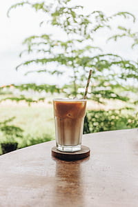clear drinking glass filled with iced coffee thumbnail