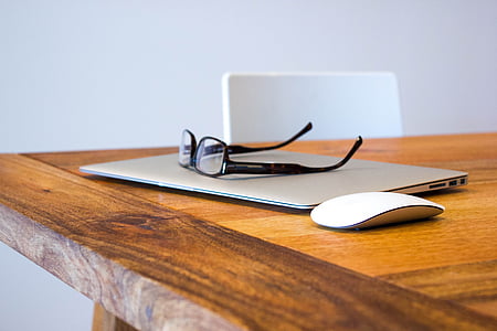 black framed eyeglasses on gray laptop computer thumbnail